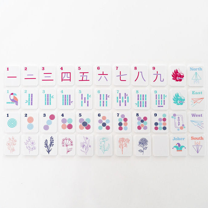 close up of mahjong tiles with cracks, bams, dots, flowers, dragons, and winds