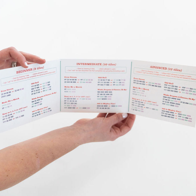 hands holding a mahjong for kids card