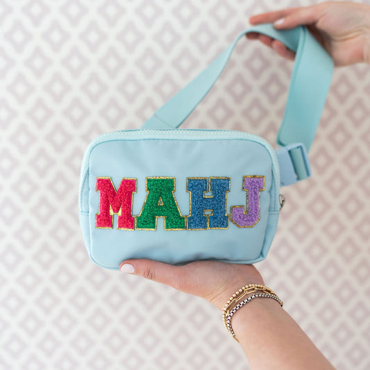 blue belt bag with "MAHJ" written on it