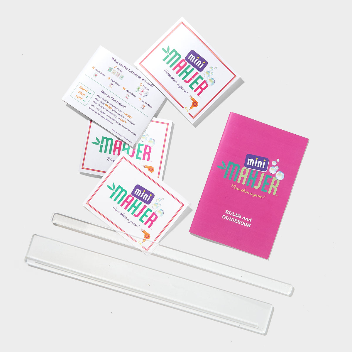 Mini Mahjer Mahjong cards, instructional guide and acrylic travel racks included in the Bubbles & Bows Edition Complete Travel Bundle